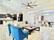 Open-concept living space with dark cabinets, neutral sofa, bright armchairs, and tile flooring at 4417 N 156Th Dr, Goodyear, AZ 85395