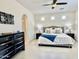 Spacious main bedroom with neutral tones, ceiling fan, ensuite bathroom, and ample natural light at 4417 N 156Th Dr, Goodyear, AZ 85395