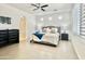 Serene main bedroom with neutral tones, shuttered windows, and an en-suite bathroom entrance at 4417 N 156Th Dr, Goodyear, AZ 85395