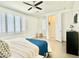 Bright main bedroom with plantation shutters, ceiling fan, and ensuite at 4417 N 156Th Dr, Goodyear, AZ 85395