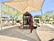 Community playground featuring a shaded play structure and seating area at 4417 N 156Th Dr, Goodyear, AZ 85395