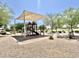 Community playground featuring covered play structure with slides and climbing elements at 4417 N 156Th Dr, Goodyear, AZ 85395