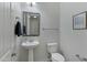 Cozy powder room with pedestal sink, framed mirror, framed art and modern fixtures at 4417 N 156Th Dr, Goodyear, AZ 85395