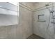 Tiled shower with rainfall showerhead, built-in niche, and grab bar at 4417 N 156Th Dr, Goodyear, AZ 85395