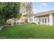 Lush backyard with a pool, artificial turf, and an outdoor seating area with umbrellas at 4901 E Lafayette Blvd, Phoenix, AZ 85018