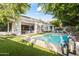 Inviting backyard with a sparkling pool, manicured landscaping, and a charming patio area at 4901 E Lafayette Blvd, Phoenix, AZ 85018