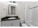 Bathroom with a granite countertop vanity, white tile, and a shower-tub combination at 4901 E Lafayette Blvd, Phoenix, AZ 85018