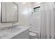 Well-lit bathroom with a marble countertop vanity, classic fixtures, and a shower-tub combo at 4901 E Lafayette Blvd, Phoenix, AZ 85018