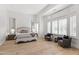 Bedroom featuring large windows with plantation shutters, hardwood floors, and sitting area at 4901 E Lafayette Blvd, Phoenix, AZ 85018