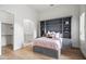 Bedroom featuring a Murphy bed with shelving, light hardwood floors, and bathroom access at 4901 E Lafayette Blvd, Phoenix, AZ 85018