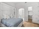 Bright bedroom featuring a Murphy bed with shelving, light hardwood floors, and closet access at 4901 E Lafayette Blvd, Phoenix, AZ 85018