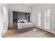 Bright bedroom featuring a Murphy bed with shelving, light hardwood floors, and french doors at 4901 E Lafayette Blvd, Phoenix, AZ 85018