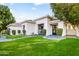 Well-manicured front lawn leading to a modern home with clean lines and dark accents at 4901 E Lafayette Blvd, Phoenix, AZ 85018