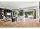 Spacious living room featuring a built-in entertainment center, sliding glass doors, and hardwood floors at 4901 E Lafayette Blvd, Phoenix, AZ 85018