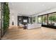 Bright, open living room with a living plant wall, large entertainment center, and sliding doors to the patio at 4901 E Lafayette Blvd, Phoenix, AZ 85018