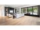 Spacious living room featuring hardwood floors, custom built-ins, large windows, and a cozy seating arrangement at 4901 E Lafayette Blvd, Phoenix, AZ 85018