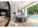 Covered patio with an outdoor dining area, lounge seating, a swimming pool, and travertine tile flooring at 4901 E Lafayette Blvd, Phoenix, AZ 85018