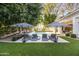 Inviting backyard pool area with lounge chairs, umbrellas, and well-manicured landscaping at 4901 E Lafayette Blvd, Phoenix, AZ 85018