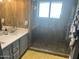 Modern bathroom featuring wood look tile, glass enclosed shower, and updated vanity at 5537 E Drummer Ave, Mesa, AZ 85206