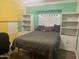 Comfortable bedroom featuring built-in bookcases flanking a bright window at 5537 E Drummer Ave, Mesa, AZ 85206
