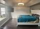 Spacious bedroom with a tray ceiling, tv, window seat, and wood floors at 5537 E Drummer Ave, Mesa, AZ 85206