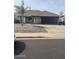Charming home with stone facade, dark garage door, and well-kept landscaping at 5537 E Drummer Ave, Mesa, AZ 85206