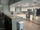Bright kitchen with granite countertops, white cabinets, stainless steel appliances and wood floors at 5537 E Drummer Ave, Mesa, AZ 85206