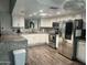 Updated kitchen features granite counters, stainless steel appliances, white cabinets and wood floors at 5537 E Drummer Ave, Mesa, AZ 85206