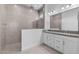 Stylish bathroom featuring a walk-in shower and a dual-sink vanity with granite countertops at 5619 N 193Rd Ave, Litchfield Park, AZ 85340