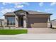 Charming single-Gathering home featuring a well-manicured lawn and a welcoming two-car garage at 5619 N 193Rd Ave, Litchfield Park, AZ 85340