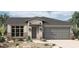 Charming single-story home with a two-car garage and desert landscaping at 5619 N 193Rd Ave, Litchfield Park, AZ 85340