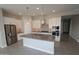 Modern kitchen featuring a center island, stainless steel appliances, and white cabinetry at 5619 N 193Rd Ave, Litchfield Park, AZ 85340