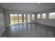 Bright living room with tile flooring, large sliding glass doors, and multiple windows at 5619 N 193Rd Ave, Litchfield Park, AZ 85340