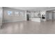 Expansive living space featuring tile floors, a kitchen, and many windows at 5619 N 193Rd Ave, Litchfield Park, AZ 85340