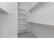 Organized walk-in closet with ample shelving and hanging space at 5619 N 193Rd Ave, Litchfield Park, AZ 85340