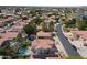 Overhead shot showcasing red-roofed Southwestern homes surrounded by lush landscaping and neighborhood streets at 5959 W Lone Cactus Dr, Glendale, AZ 85308