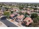 Aerial view of houses with desert landscaping, tile roofs, and a private pool in the backyard at 5959 W Lone Cactus Dr, Glendale, AZ 85308