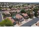 A high angle aerial shot shows tile roofs, desert landscaping, and neighborhood streets at 5959 W Lone Cactus Dr, Glendale, AZ 85308