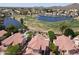 Picturesque aerial shot overlooking homes with red tile roofs near a lush green golf course and peaceful lake at 5959 W Lone Cactus Dr, Glendale, AZ 85308