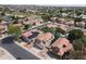 High-angle view of Southwestern-style homes, showcasing tiled roofs,desert landscaping, and community streets at 5959 W Lone Cactus Dr, Glendale, AZ 85308