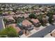Aerial view highlighting Southwestern-style homes with solar panels, red tile roofs, desert landscaping, and neighborhood streets at 5959 W Lone Cactus Dr, Glendale, AZ 85308