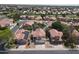 High-angle view of Southwestern-style homes, showcasing tiled roofs,desert landscaping, and community streets at 5959 W Lone Cactus Dr, Glendale, AZ 85308