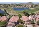 Scenic aerial of homes bordering a golf course and lake, complemented by Southwestern architectural design and landscape at 5959 W Lone Cactus Dr, Glendale, AZ 85308