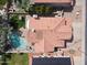 Bird's-eye view of a meticulously maintained red-roofed home, patio, swimming pool, and solar panels in a residential area at 5959 W Lone Cactus Dr, Glendale, AZ 85308