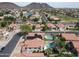 Stunning aerial view showcasing red-roofed homes, green landscapes, and a serene lake in a well-planned community at 5959 W Lone Cactus Dr, Glendale, AZ 85308