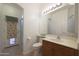 Bathroom featuring a sink with a vanity, toilet, and a glass enclosed shower at 5959 W Lone Cactus Dr, Glendale, AZ 85308