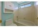 Bathroom featuring a toilet and tub/shower combo with tiled walls at 5959 W Lone Cactus Dr, Glendale, AZ 85308