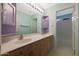 Bathroom with double vanity, large mirror, and a combined shower and tub at 5959 W Lone Cactus Dr, Glendale, AZ 85308