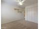 Bedroom with neutral carpet, overhead fan, a closet and two floating shelves at 5959 W Lone Cactus Dr, Glendale, AZ 85308