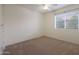 Bedroom with beige carpet, fresh paint, and a window providing natural light at 5959 W Lone Cactus Dr, Glendale, AZ 85308